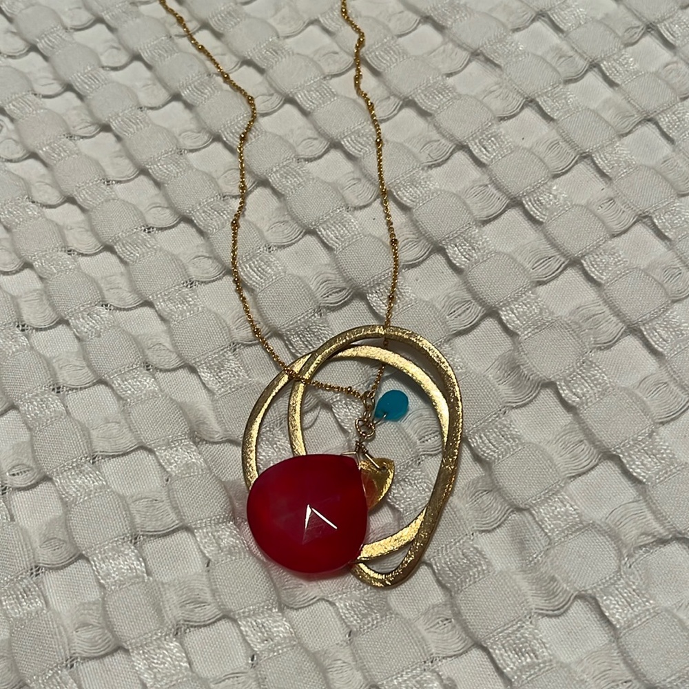 Beautiful long contemporary necklace with red and blue stone.